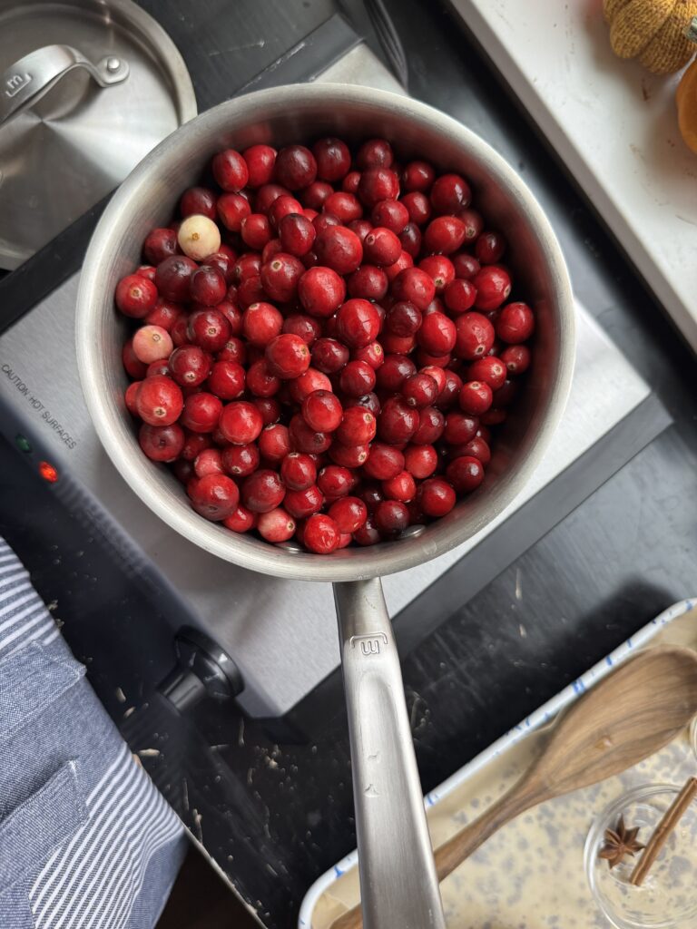 Simmering cranberries in a sauce pan.