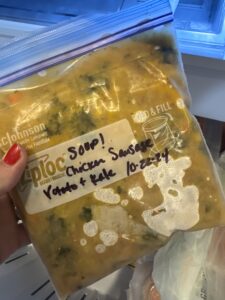 Image of a quart-sized zip top bag of frozen Creamy Parmesan Italian Sausage Soup with label and date.
