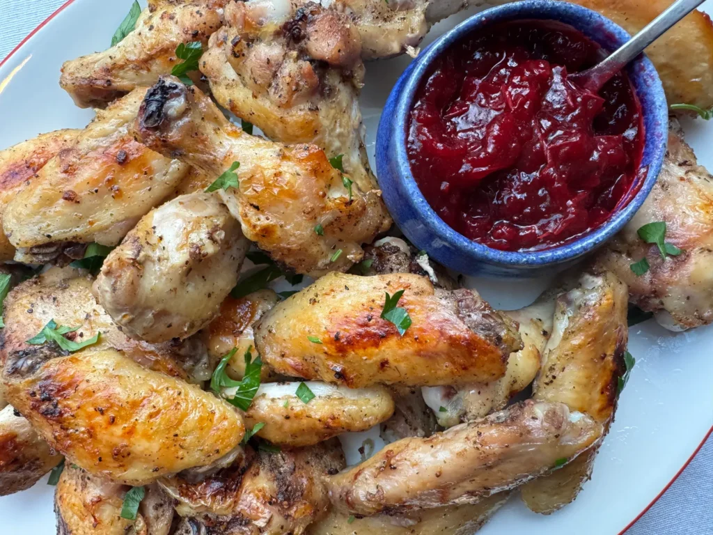 Dry Rub Chicken Wings with a side of Whole Berry Cranberry Sauce.
