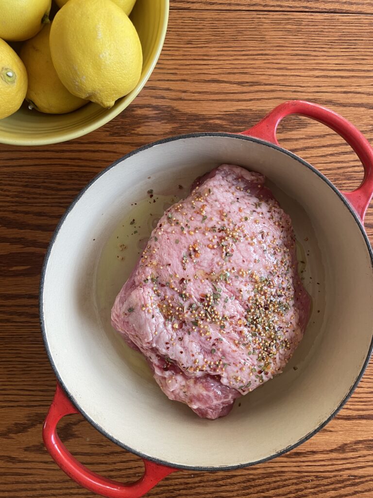 Corned beef roast in a Dutch oven, ready to be roasted.