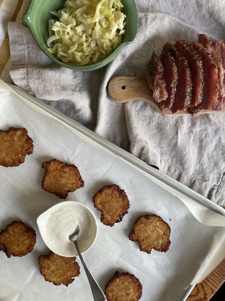 Latkes ready to be assembled with sliced corned beef and cabbage.