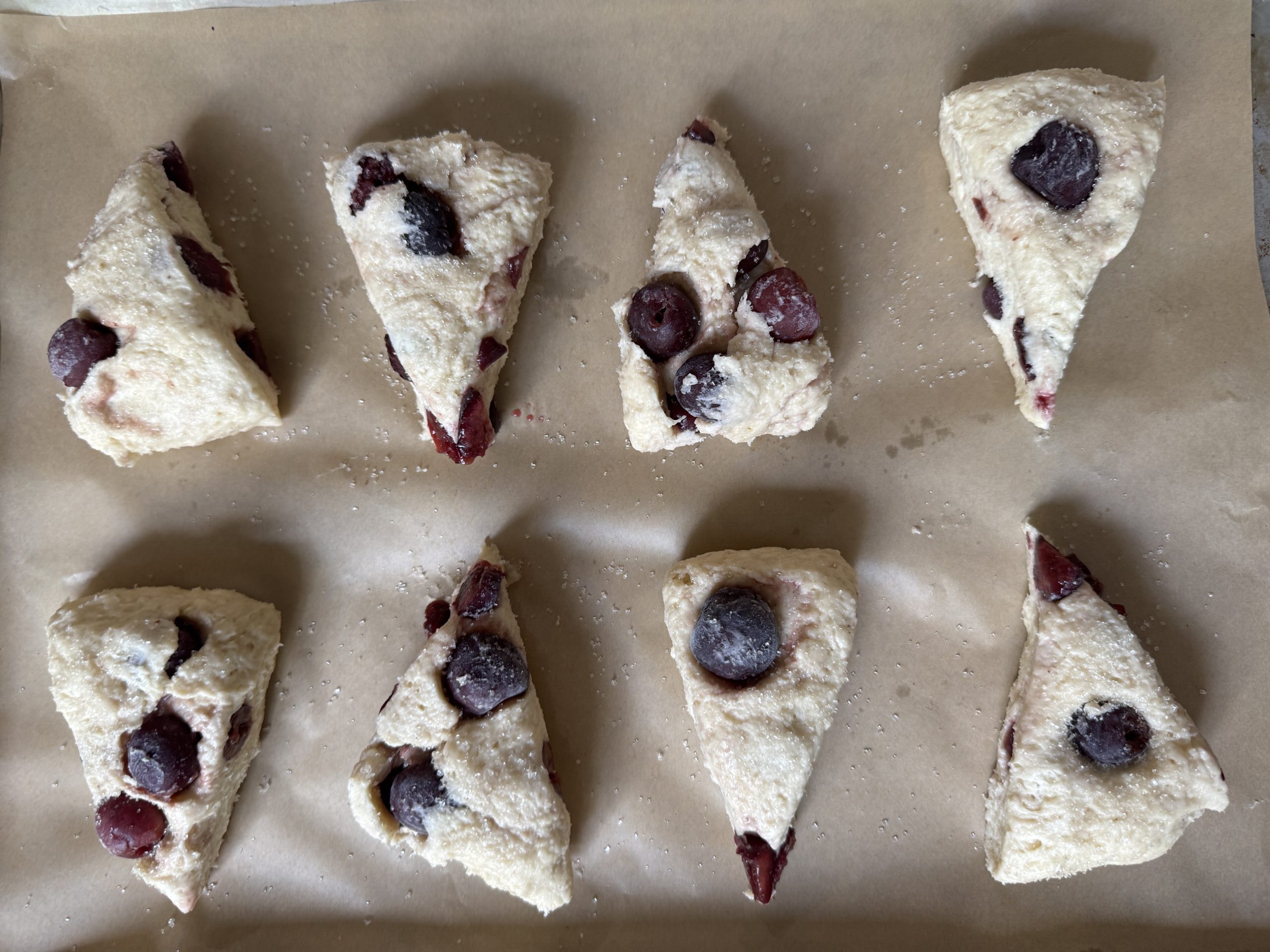 Overhead view of sliced scone dough, ready to be baked.