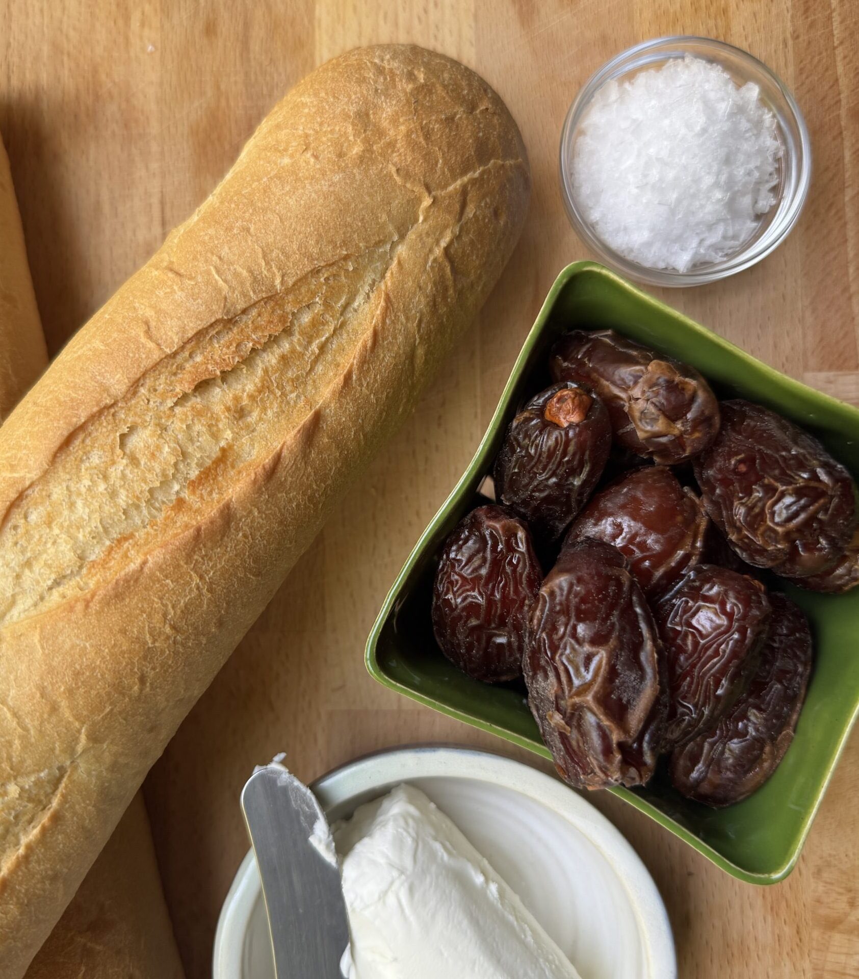 Ingredients for Goat Cheese Crostini: Baguette, goat cheese, Medjool dates, flaky sea salt.
