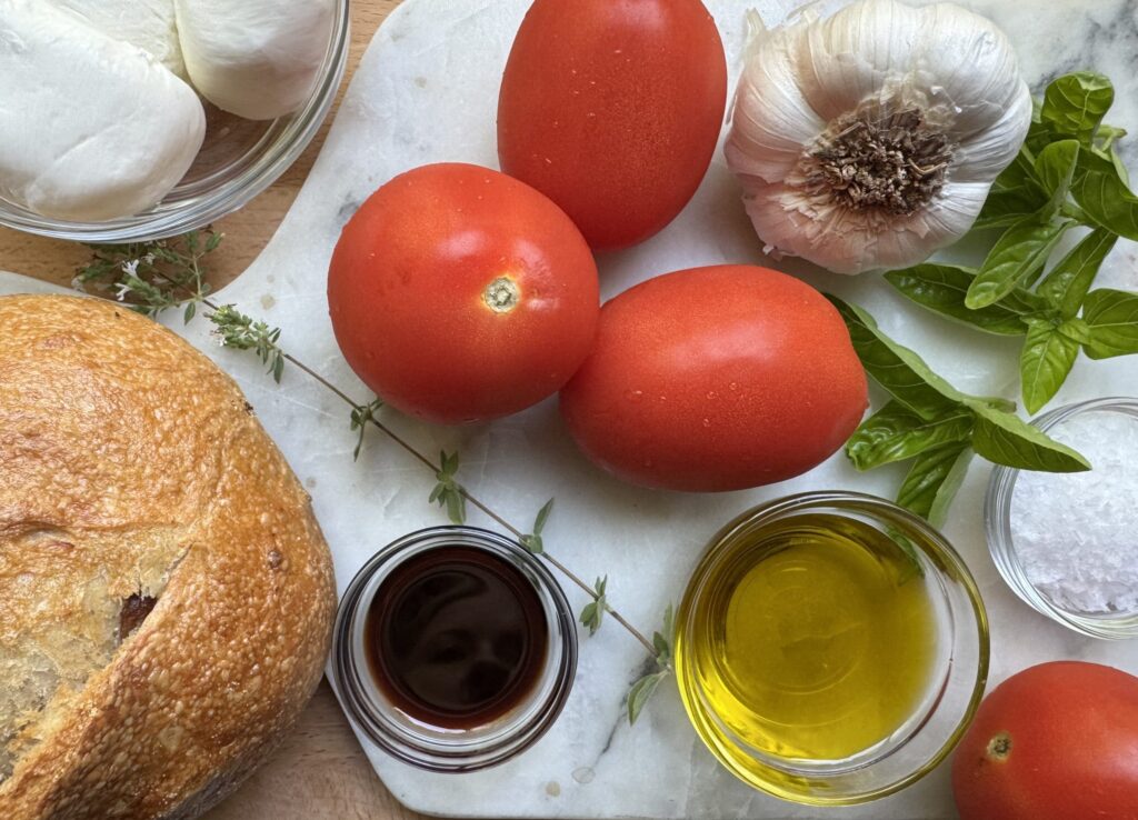 Ingredients for Burrata Bruschetta: Sourdough bread, Roma tomatoes, garlic, herbs, olive oil, balsamic vinegar, burrata.