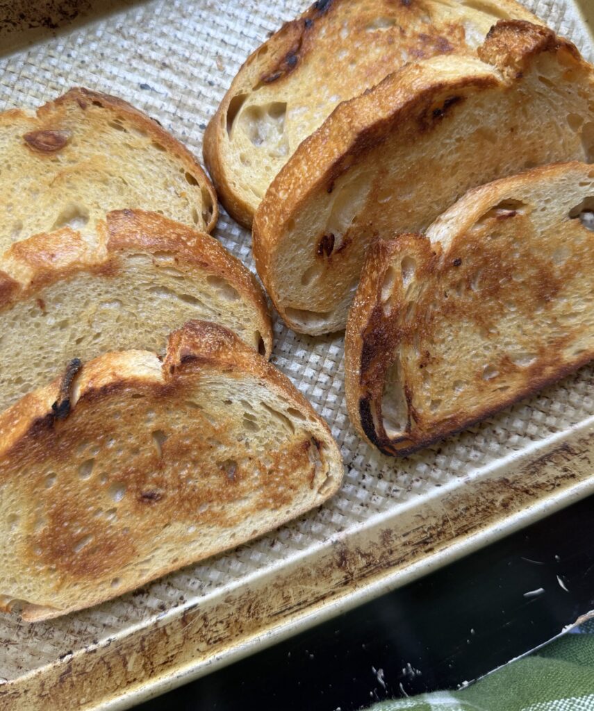 Toasted rounds of sourdough, ready for the tomato bruschetta topping.