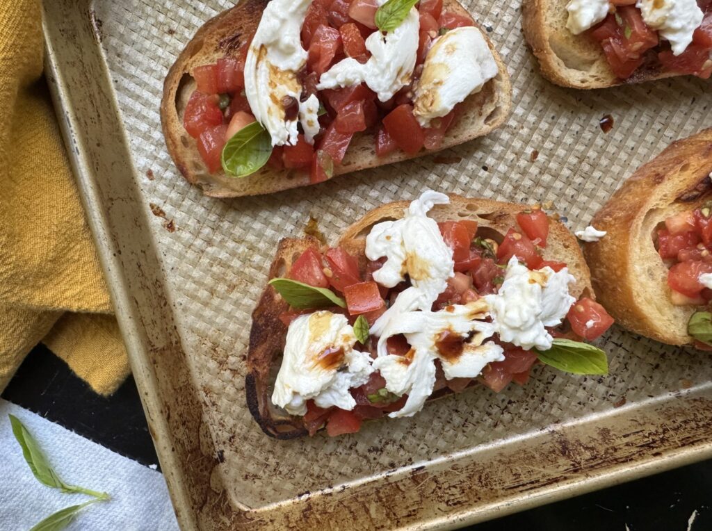Finished product: Burrata Bruschetta with balsamic and basil.