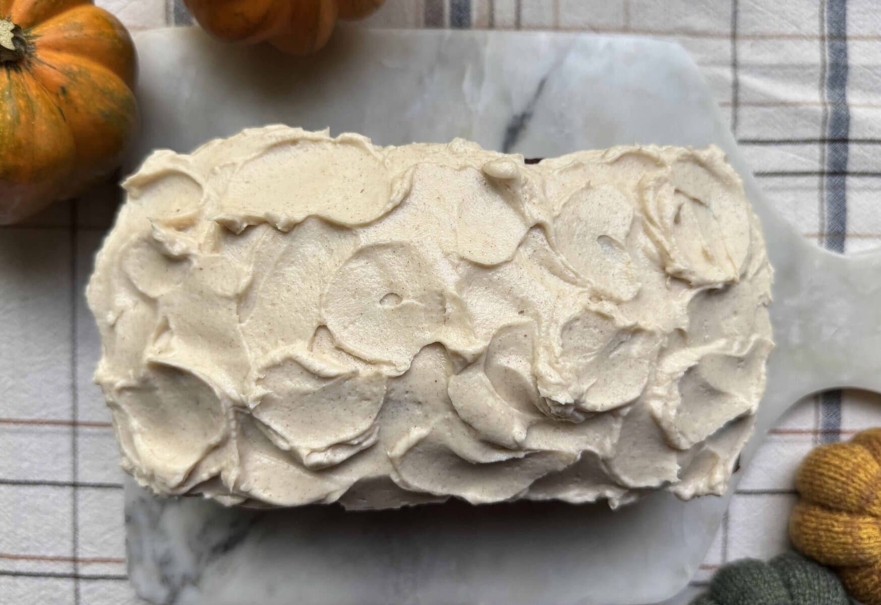 Brown Butter Cream Cheese Frosting on a Pumpkin Bread loaf.