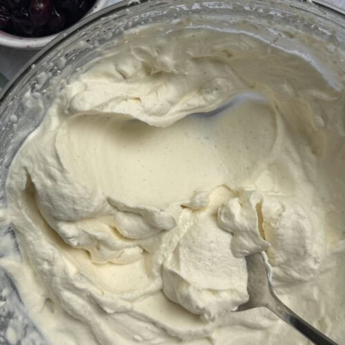 Whipped cream with a side of blueberries.