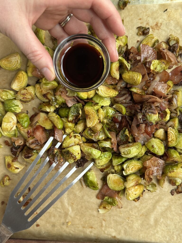 Sprouts, prosciutto, and shallots fully combined. Finishing balsamic glaze / aged vinegar pouring over top.