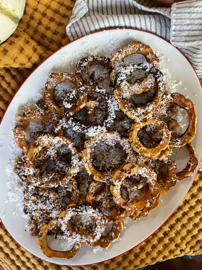 Platter of delicata squash with parmesan and breadcrumbs.
