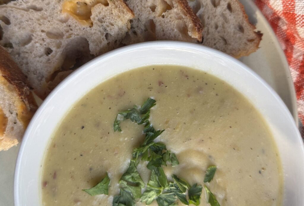Creamy potato leek soup without cream served with cheddar and chive sourdough bread