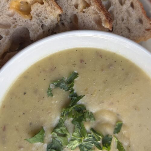 Creamy potato leek soup without cream served with cheddar and chive sourdough bread