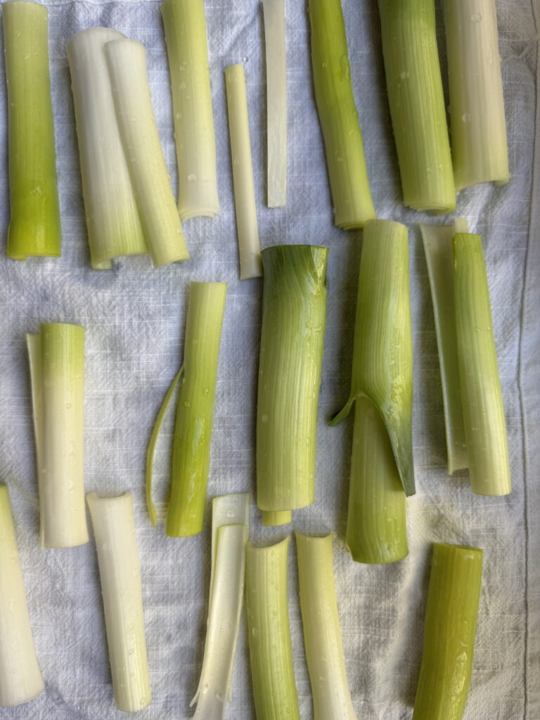 Leeks drying after being washed, laying flat on a paper towel