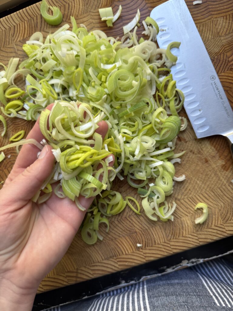 Finely chopped leeks on a cutting board.