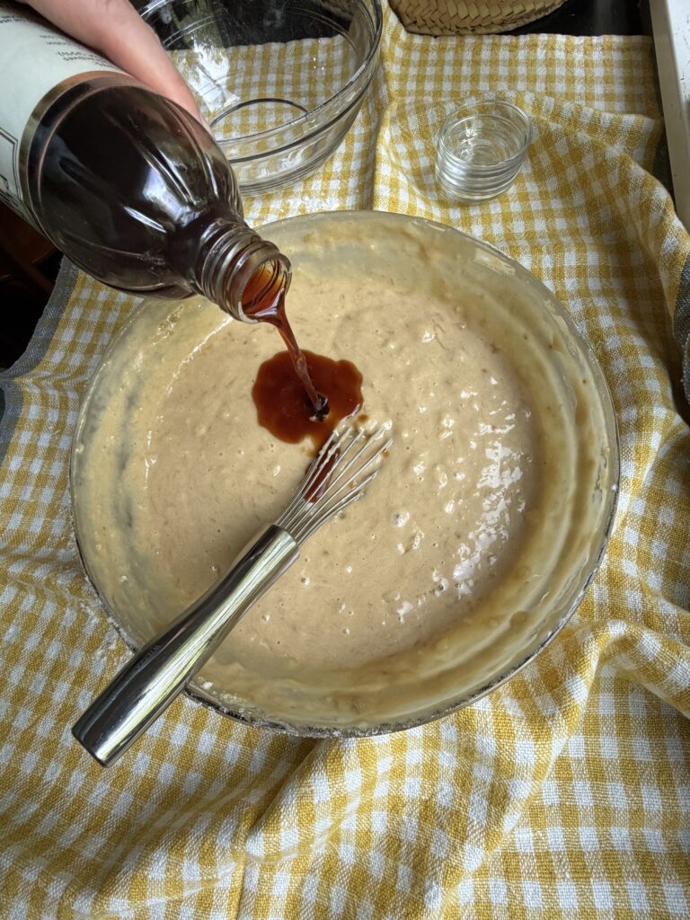 Wet ingredients for banana nut bread with chocolate chips with vanilla extract