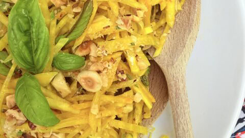 Raw golden beet salad with basil, mint, and toasted hazelnuts