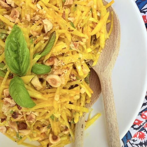 Raw golden beet salad with basil, mint, and toasted hazelnuts