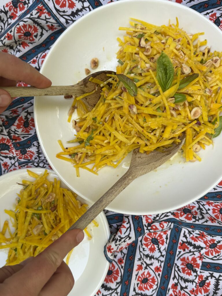 Raw golden beet salad with basil, mint, and toasted hazelnuts