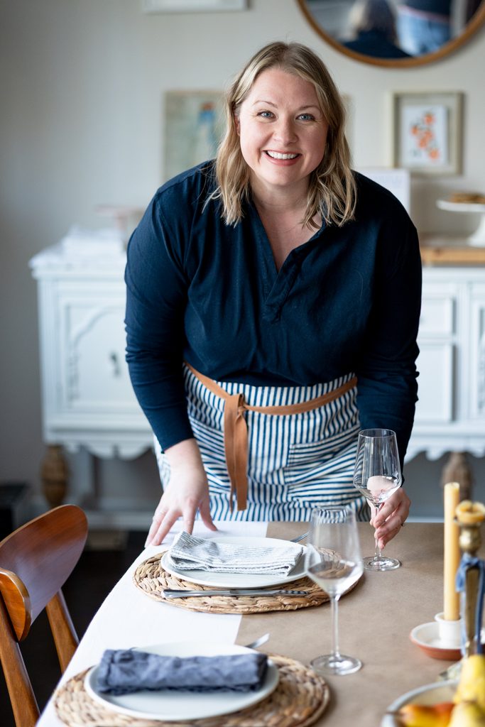 Amber setting a simple table for gathering.
