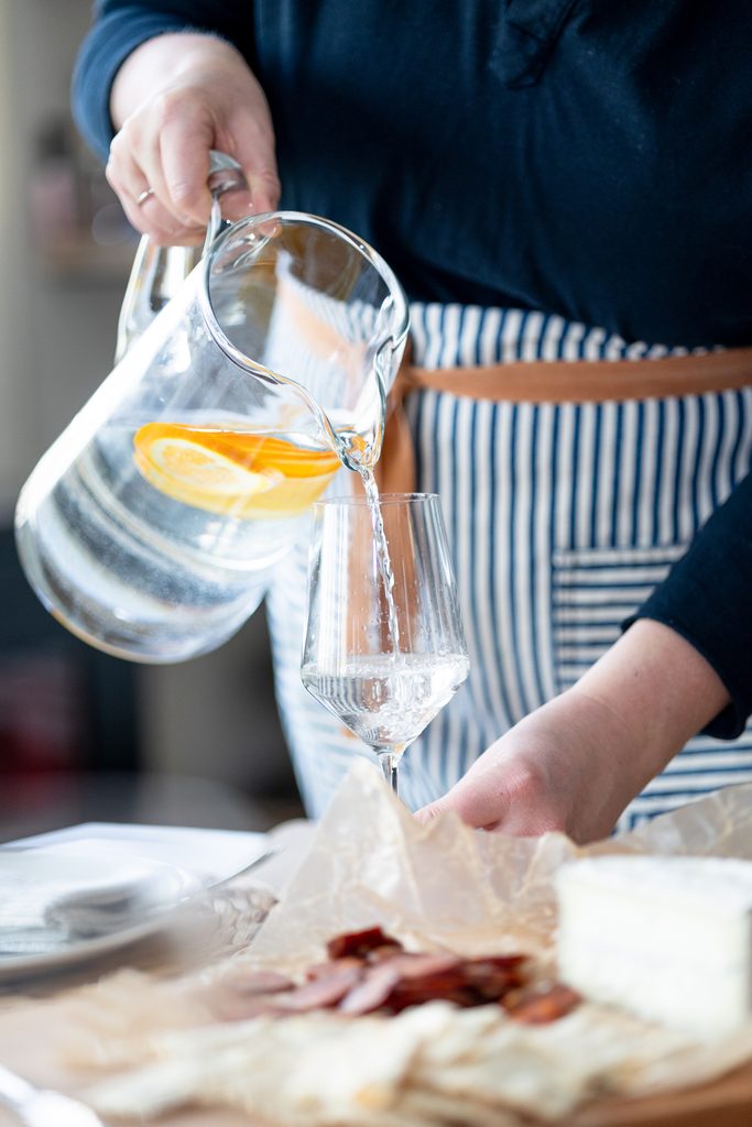 Amber pouring water from a pitcher into a glass.