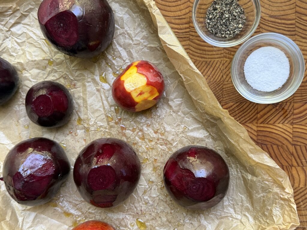Beets on a baking sheet with salt and pepper seasonings