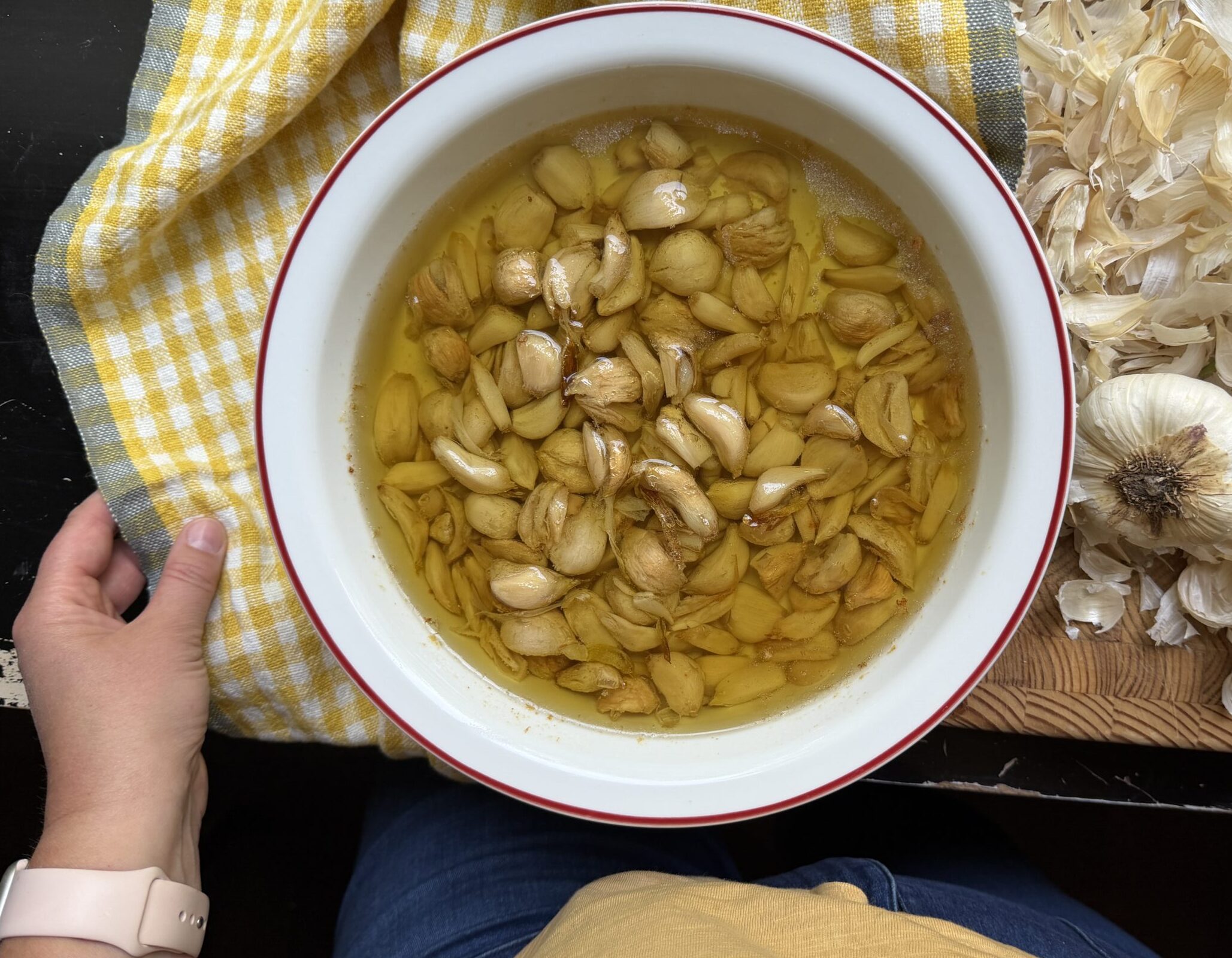 Garlic confit finished product with chef's hands