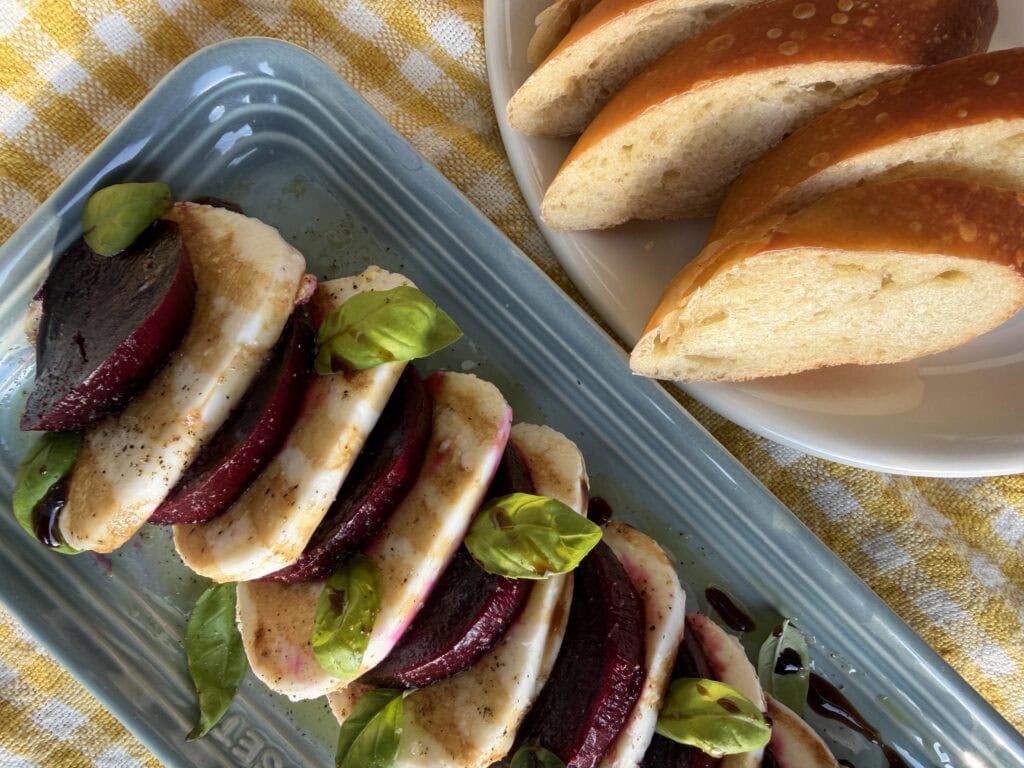 Roasted beets served with mozzarella and basil with crostini bread slices