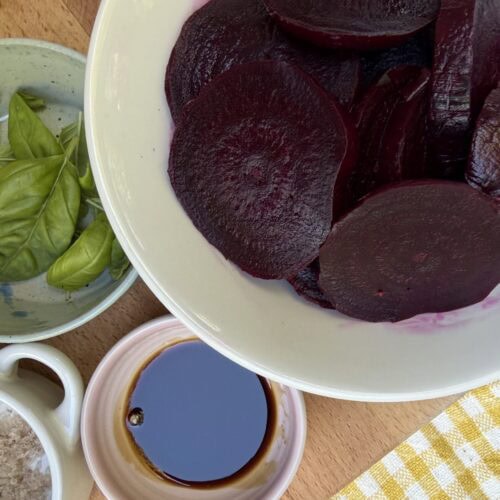 Roasted beets with serving ingredients (basil, flaky salt, black pepper, olive oil)