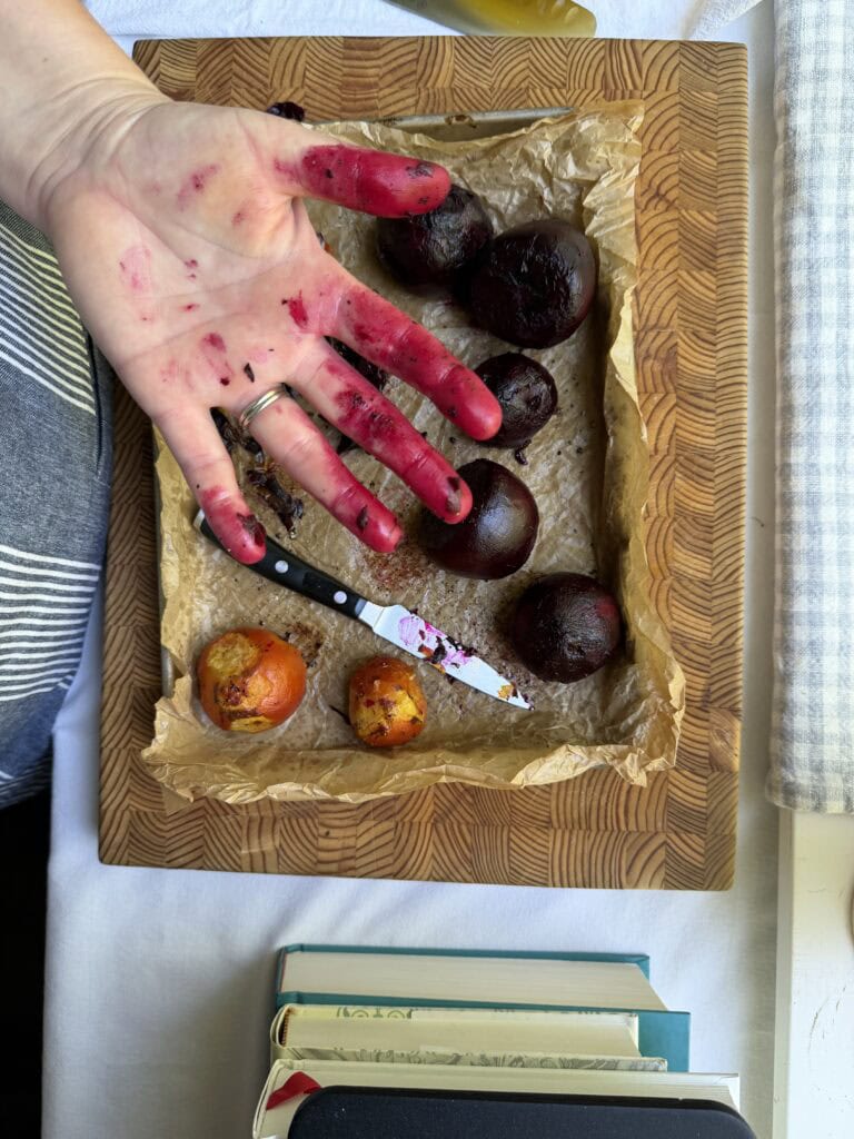 Stained chef's hands with red and golden beets