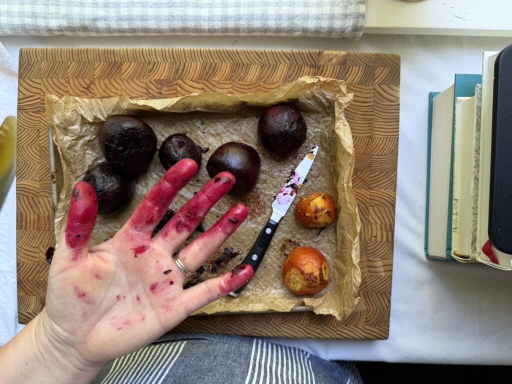 Stained chef's hands with red and golden beets