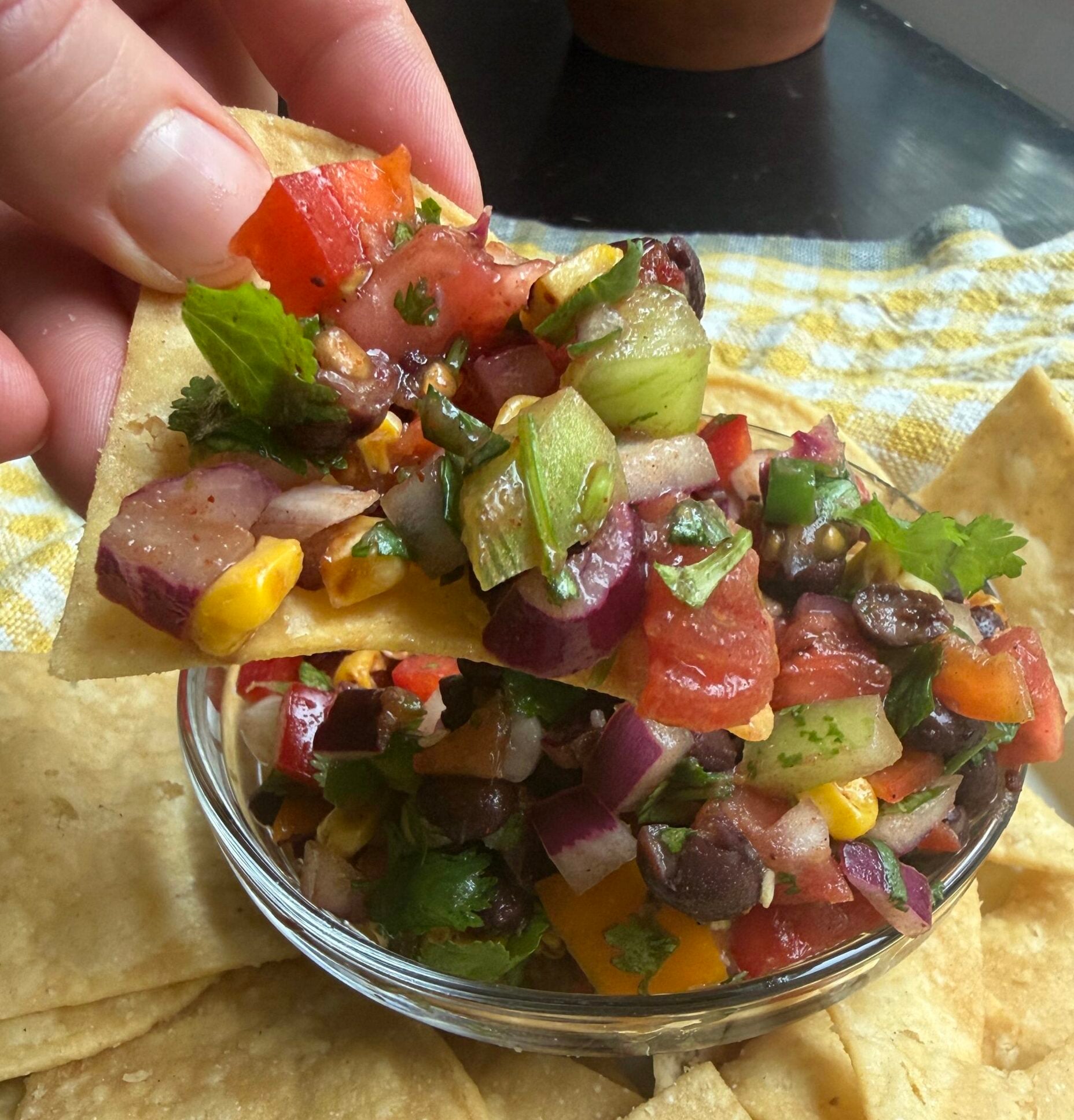 Prepared salsa in a clear bowl and tortilla chips.