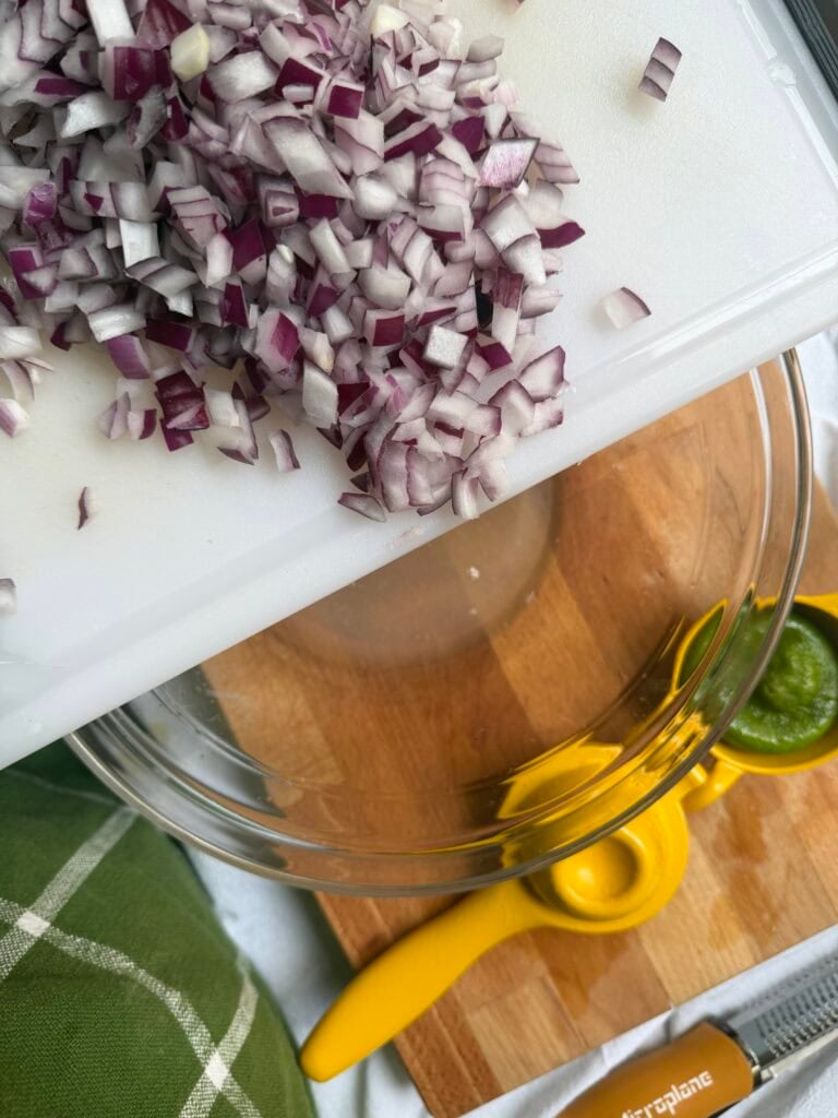Diced onions on a cutting board.